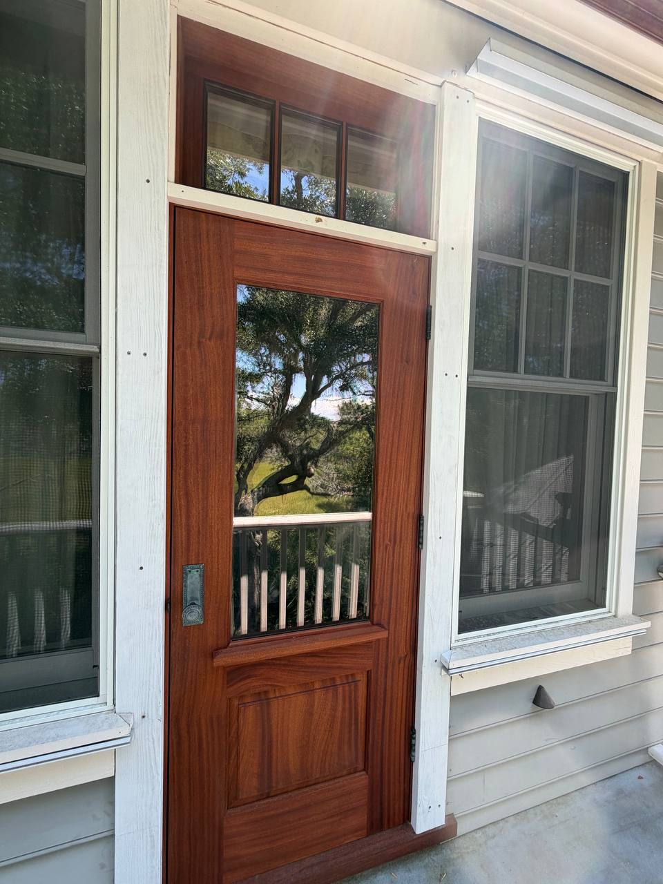 A finished Sapele glass-panel door installed on a Lowcountry home